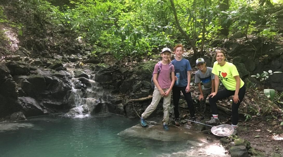 Middle school students stop by the waters edge while completing a wildlife survey in Costa Rica Projects Abroad volunteers take a break in the forest during their Conservation Project